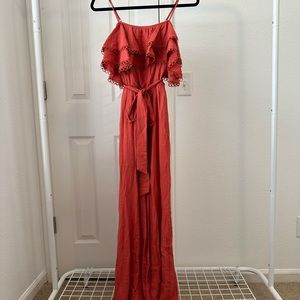 Red-orange jumpsuit with ruffle detailing